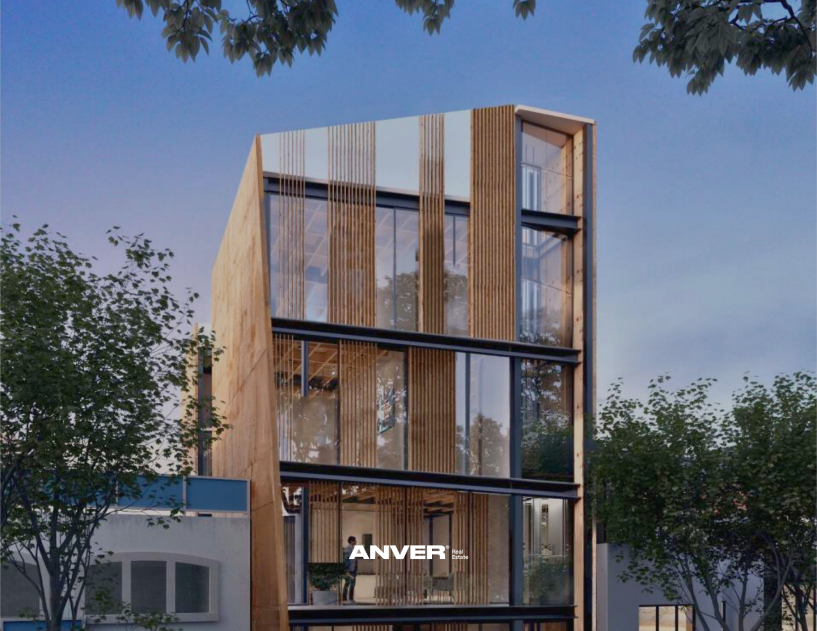Edificio moderno de varios pisos con estructura de madera y grandes ventanas de vidrio, rodeado de árboles.