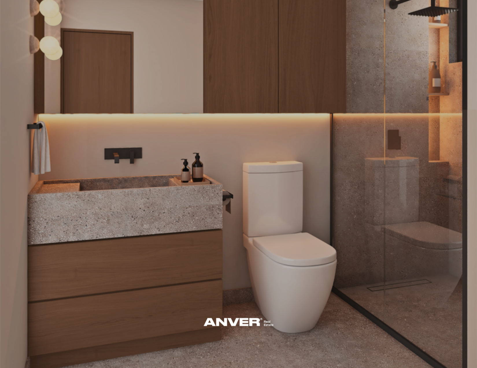 Baño moderno con lavamanos de piedra, inodoro blanco, armarios de madera y ducha con puerta de cristal y paredes de piedra.