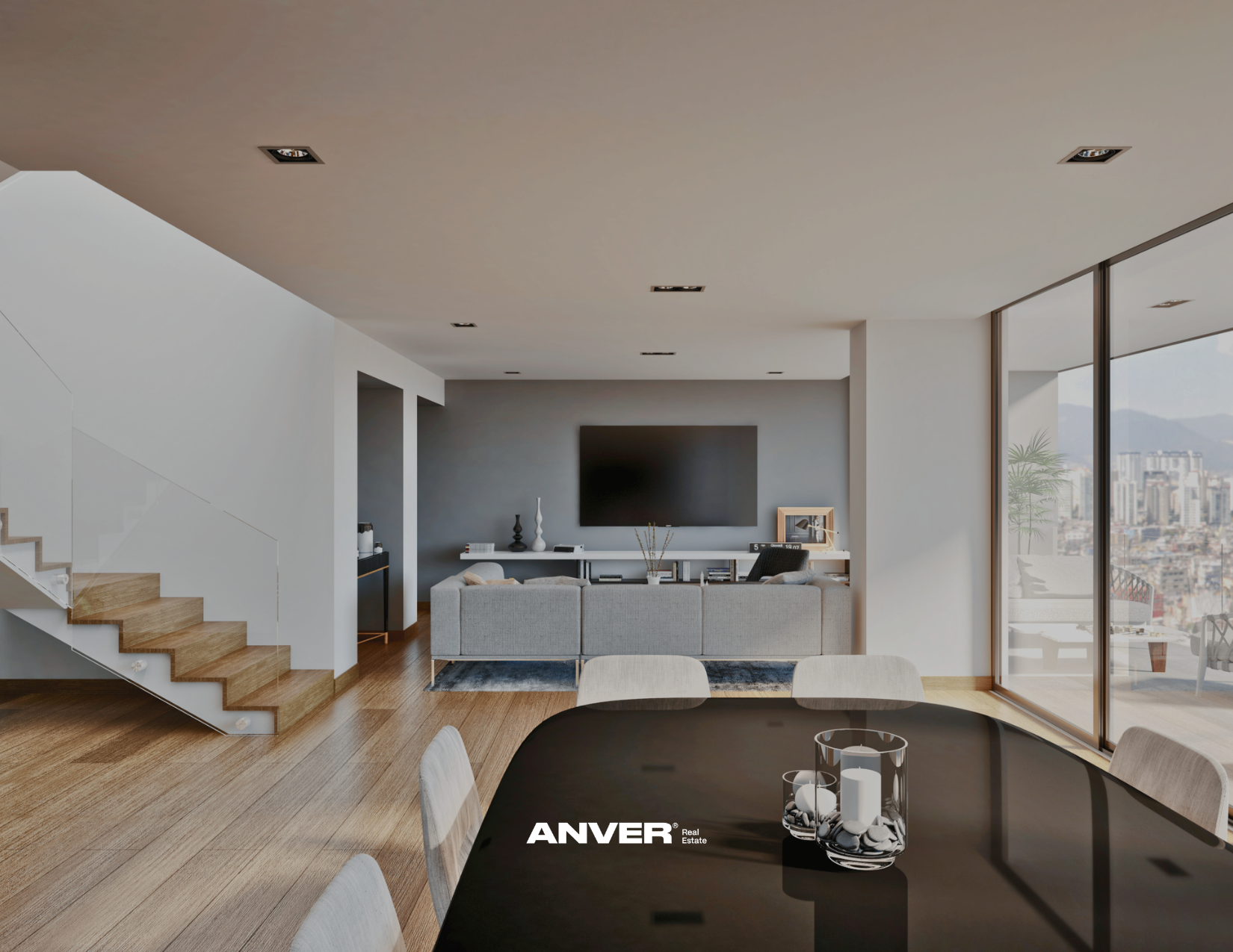 Vista de una sala moderna en un apartamento con ventanas grandes que ofrecen una vista de la ciudad con edificios y montañas, interior decorado en tonos neutros con sofá gris, mesa de centro y televisión en la pared
