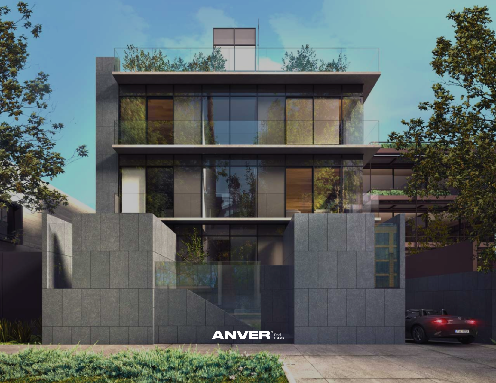 Edificio moderno de varios pisos con fachada de vidrio y estructura de concreto, rodeado de árboles y césped, con un coche negro estacionado en la entrada.