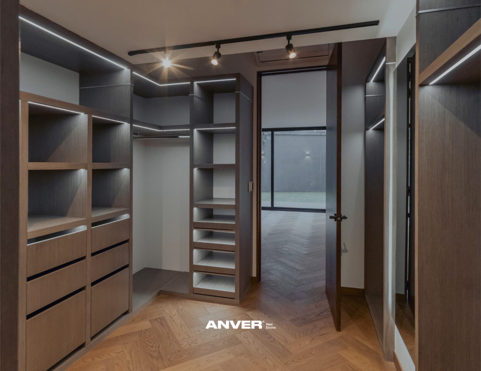 Armario de madera con estantes y cajones en una habitación moderna, con puertas de vidrio y suelo de madera.