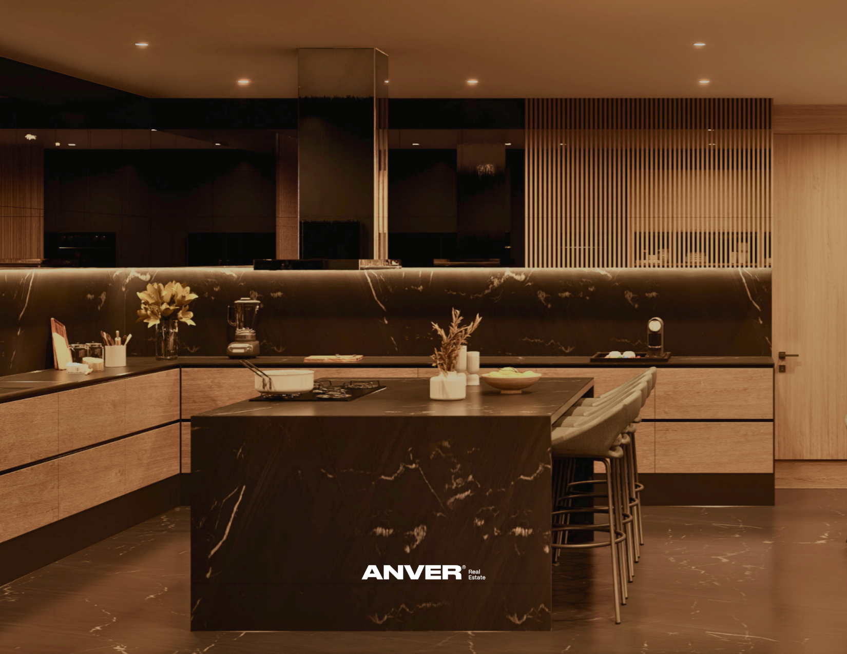 Cocina moderna con encimera de piedra negra con vetas blancas, utensilios y plantas decorativas, iluminación cálida y mobiliario de madera clara y gris, marca ANVER.
