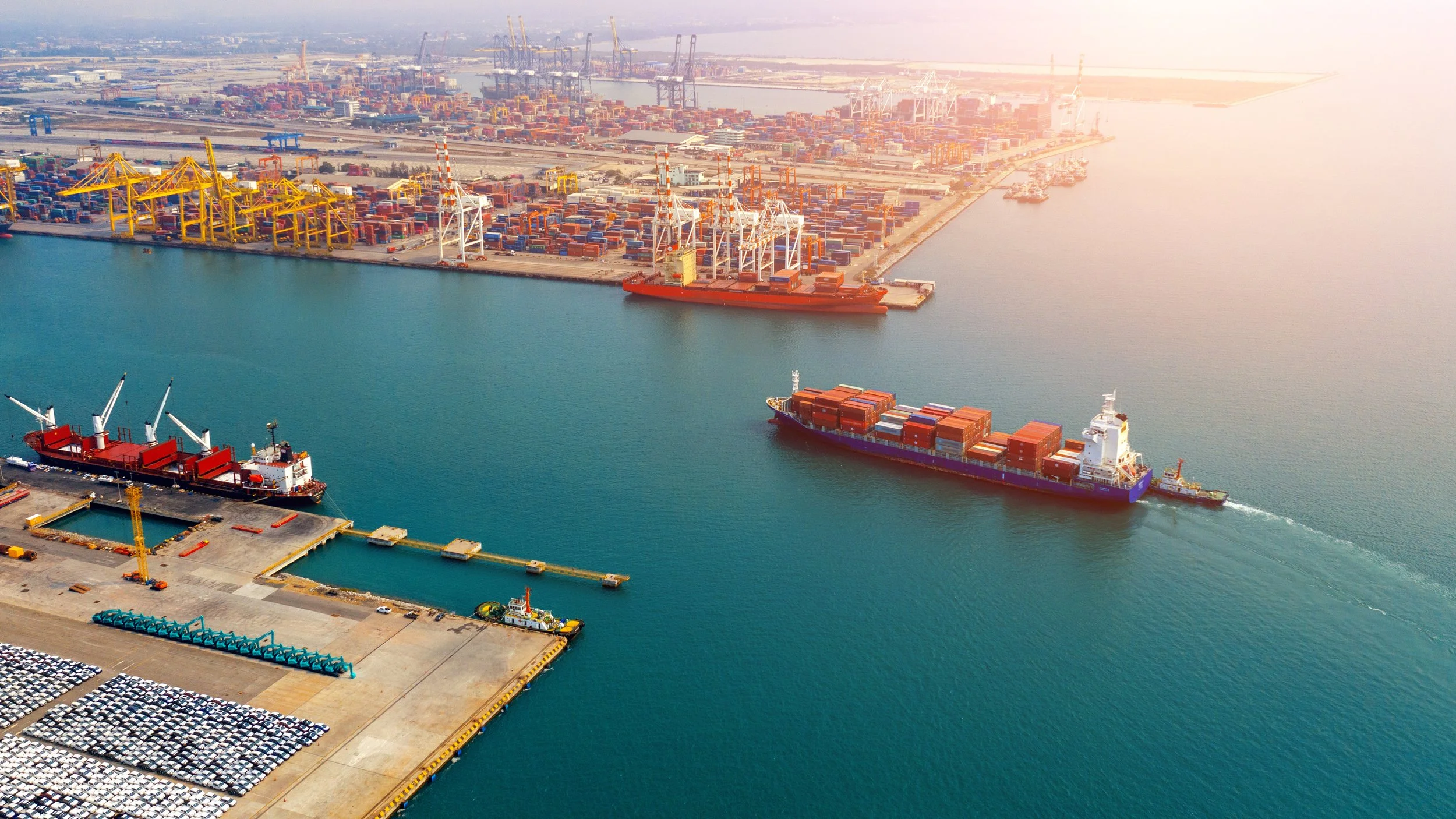 Large container ship approaching a busy seaport