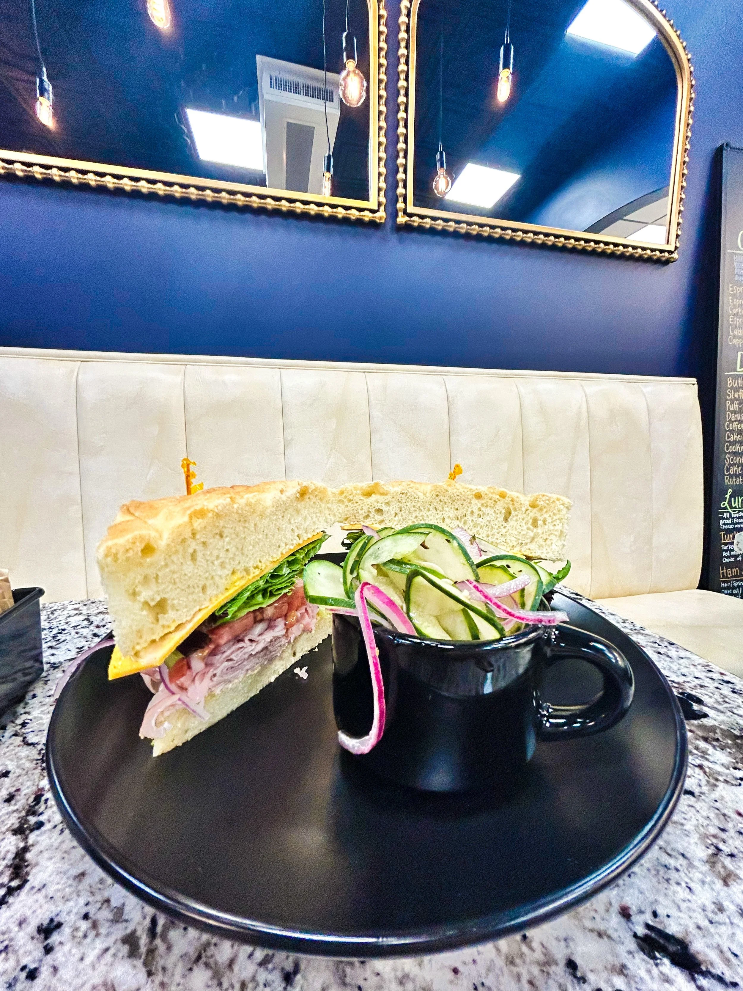 Our Grand Ham Sammy! Ham / Spring mix / Tomato / Red onion / Garlic aioli / Olive oil / Red wine vinegar / Salt and pepper. Choice of lunch bread &amp; cheese.