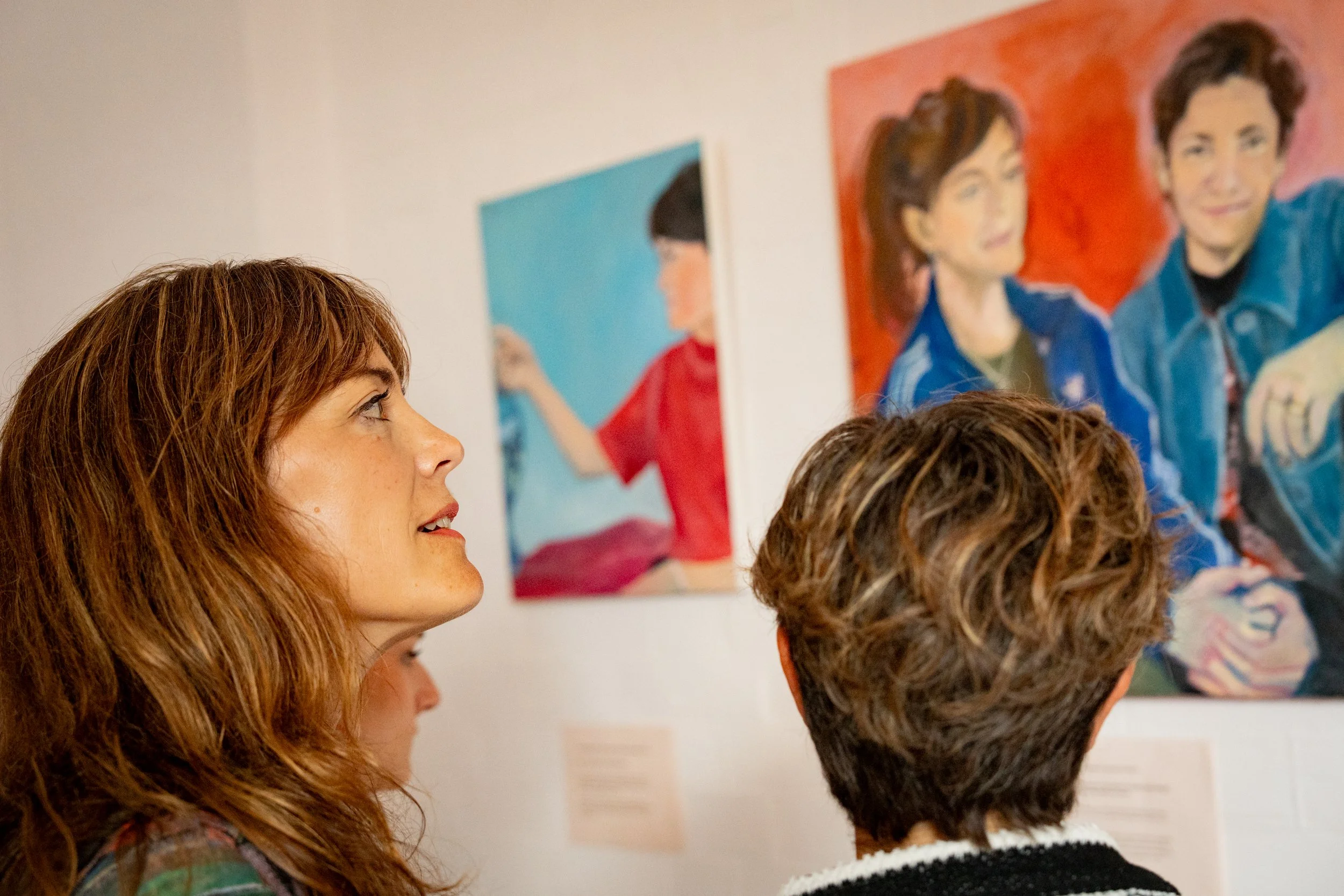 elli in focus looking at her portrait.jpg