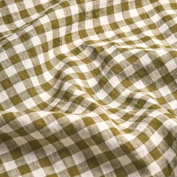 Close-up of a green and white checkered fabric with some wrinkles.