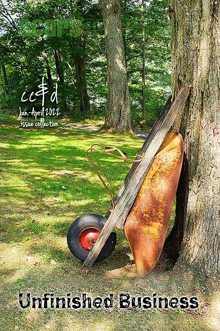 A rusted wheelbarrow and wooden board leaning against a large tree in a green wooded area, with text overlay reading 'January-April 2021 issue collection' and the title 'Unfinished Business'