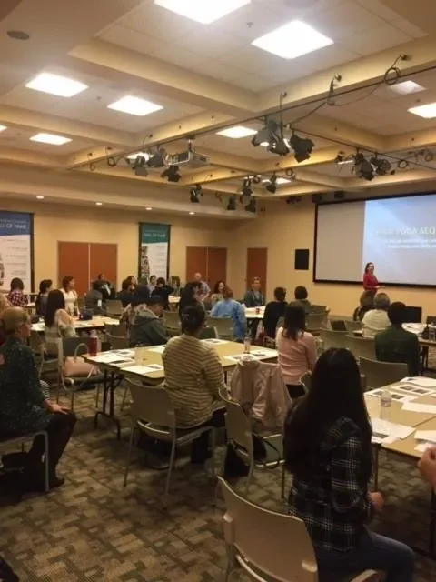 Lauren Polly speaking at a corporate healthcare event on patient-caregiver communication and human connection