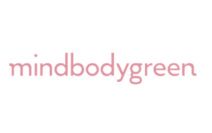 MindBodyGreen logo in pink letters on a white background