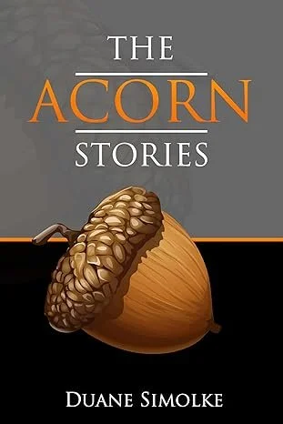 Book cover for The Acorn Stories by Duane Simolke featuring a detailed illustrated acorn on a gray and black background, with the title in white and orange serif text. Image shared by Selfpublishing360.com