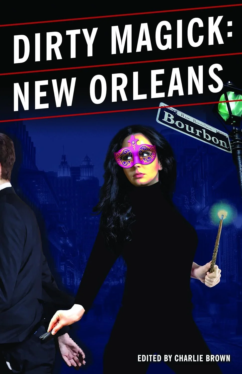 Book cover titled "Dirty Magick: New Orleans," edited by Charlie Brown. The cover features a woman with black hair wearing a purple masquerade mask and holding a lit magic wand, set against a cityscape with a street sign reading "Rue Bourbon" in New 
