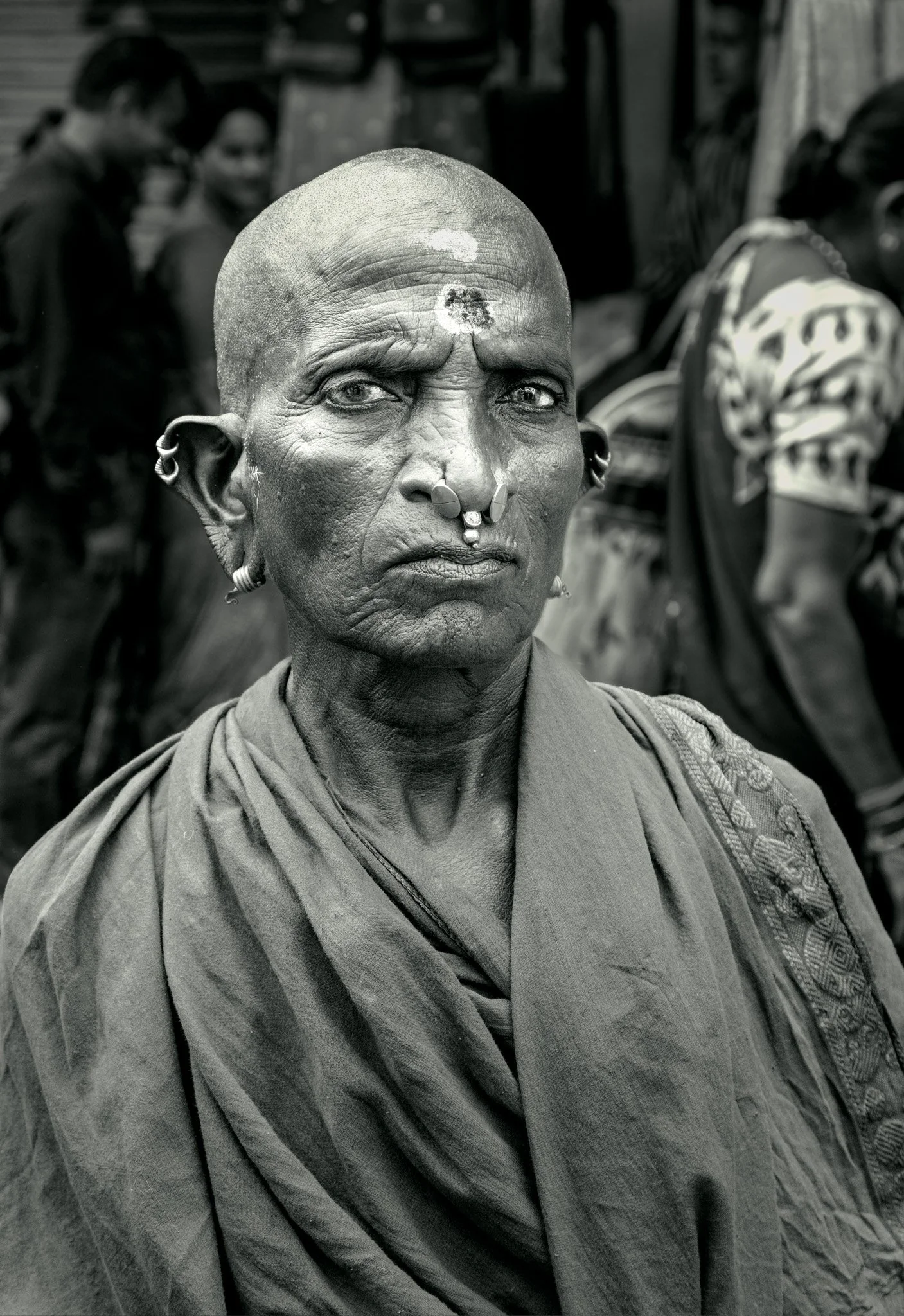 
She carries something older than herself. Varanasi, India. 2025.