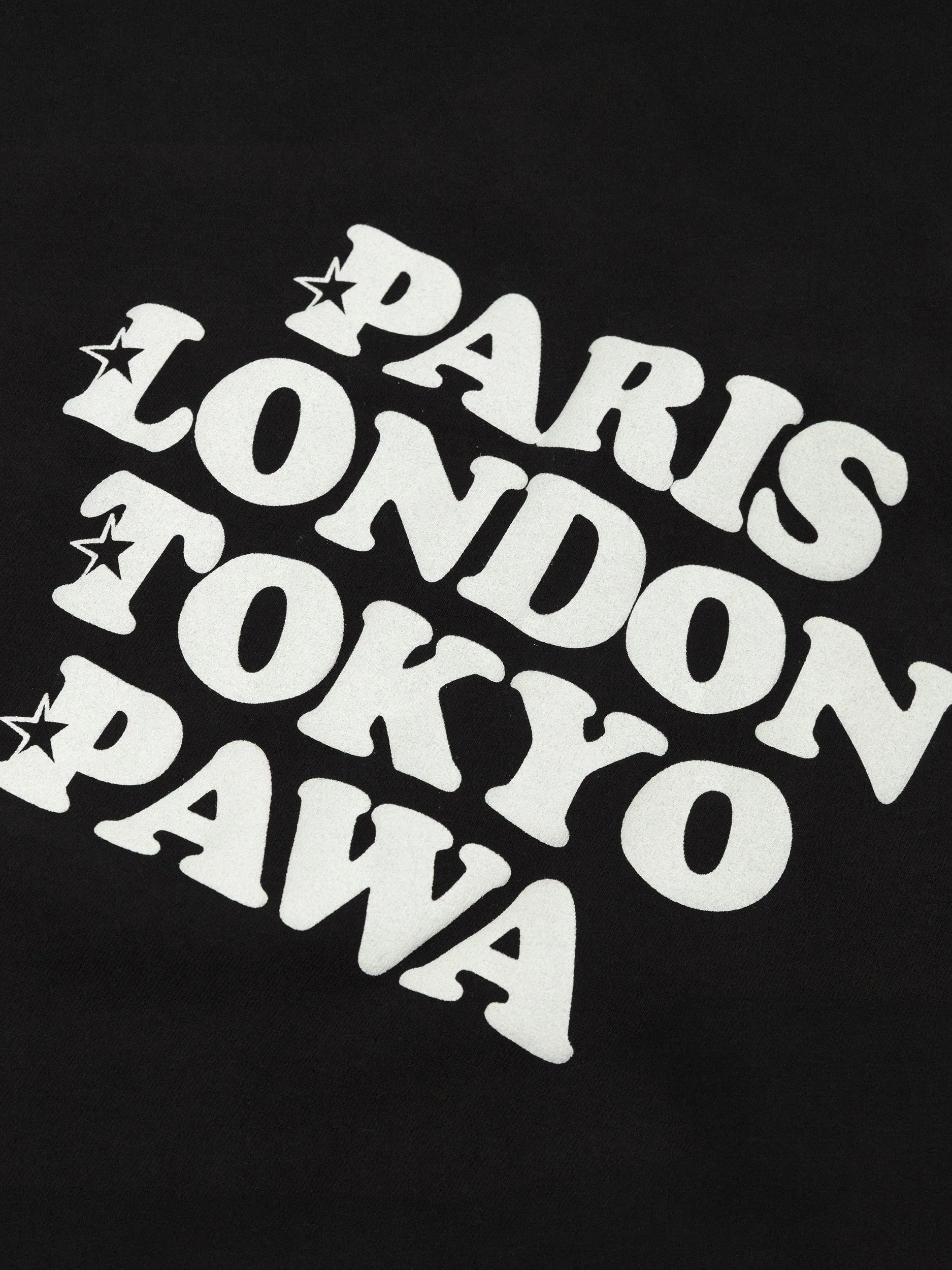 Close-up of a black T-shirt with white text that reads "DARK S LOVING" with star accents.