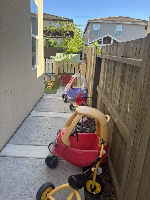 Children’s outdoor play area with riding toys and hands-on play activities at preschool
