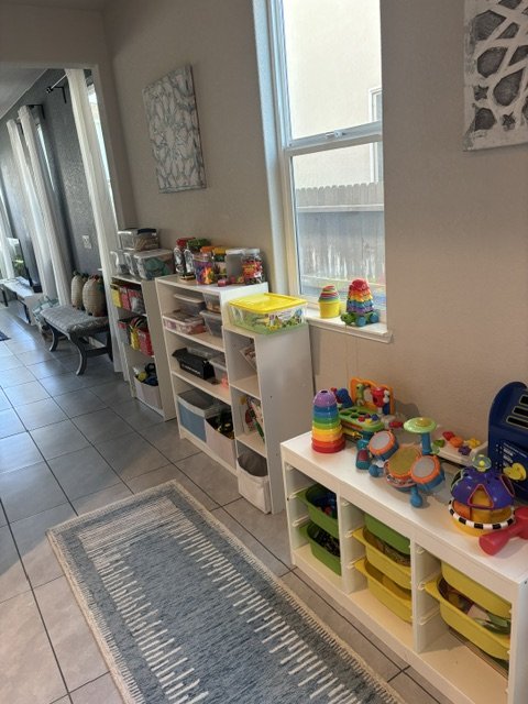 Cozy preschool reading corner with bookshelves, educational toys, and learning materials