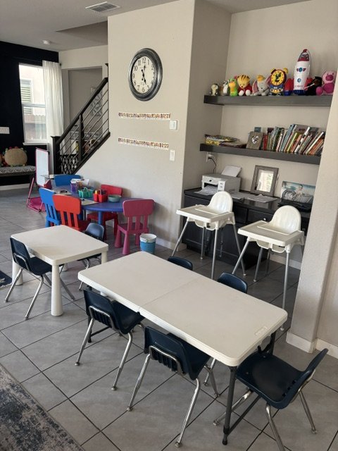 Preschool classroom with tables, educational activities, and group learning environment