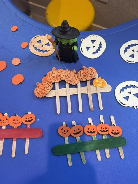 Colorful Halloween pumpkin crafts made with craft sticks and paper during a creative preschool activity at BabeeShark in Sacramento
