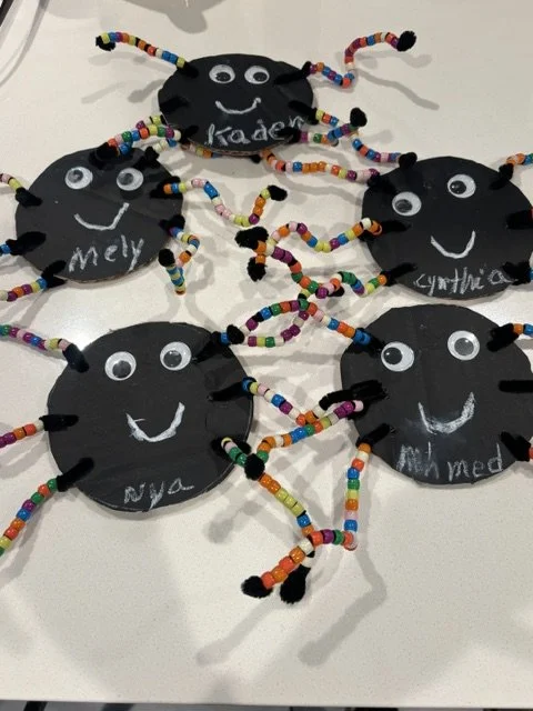 Preschool children’s handmade Halloween spider crafts featuring colorful beaded legs, googly eyes, and smiling faces at BabeeShark Preschool in Sacramento