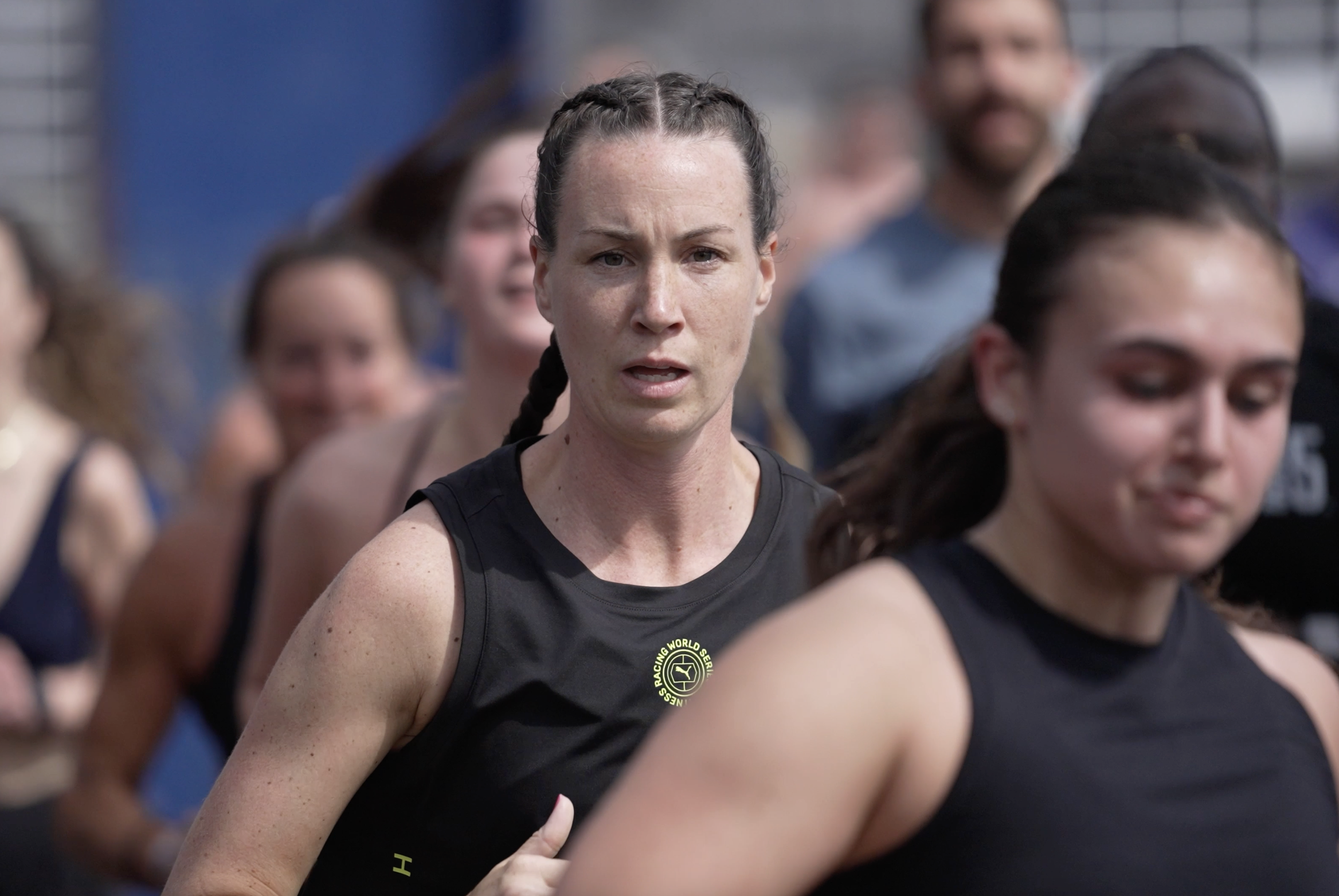 Michelle Hughes from My Journey To Just Live running in her first HYROX event, surrounded by other runners. 