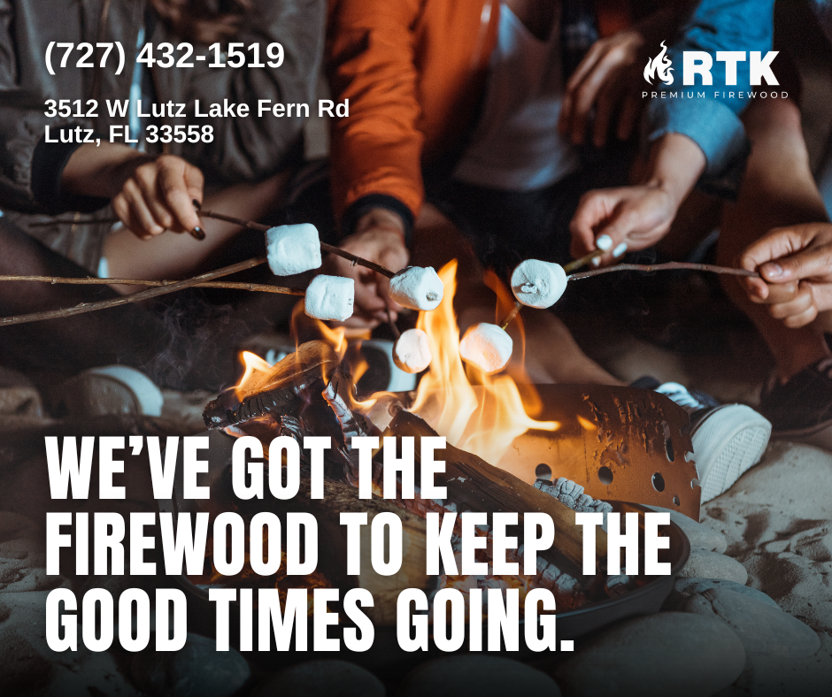 People roasting marshmallows over an open fire on a beach at night with rocks in the foreground, promoting firewood supplies.