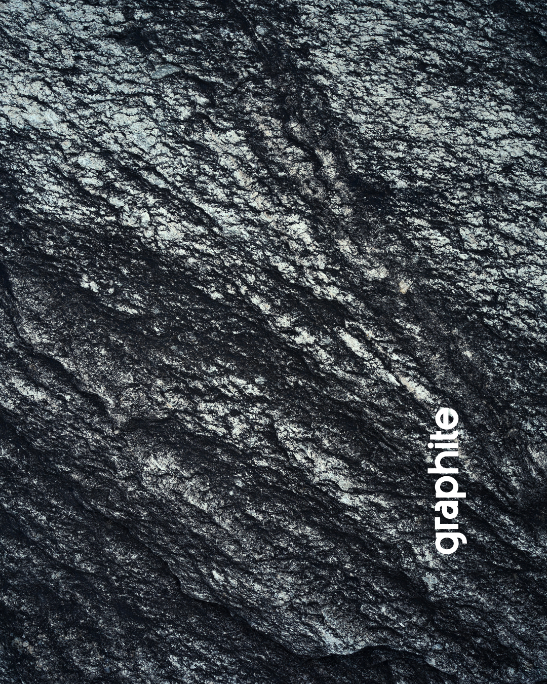 Close-up of textured dark gray granite surface with white veins