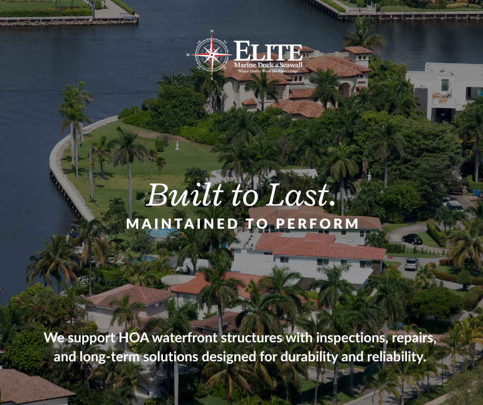 Aerial view of a waterfront residential community with lush greenery, palm trees, and houses with red-tiled roofs along the water's edge.