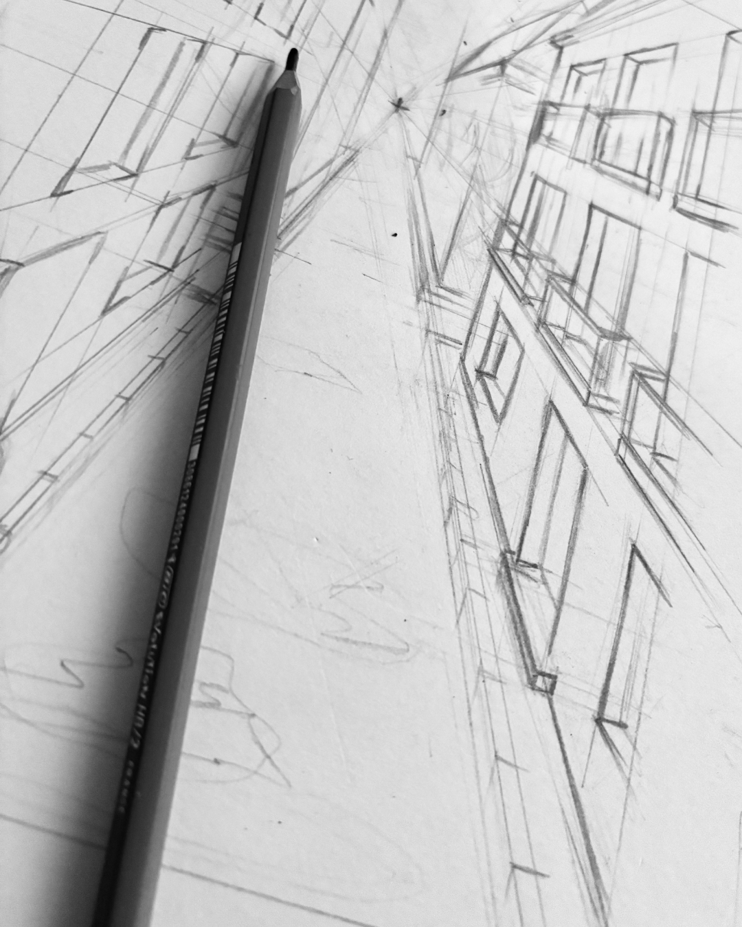 A pencil drawing of an urban city street scene, with buildings on both sides, sketched on white paper.