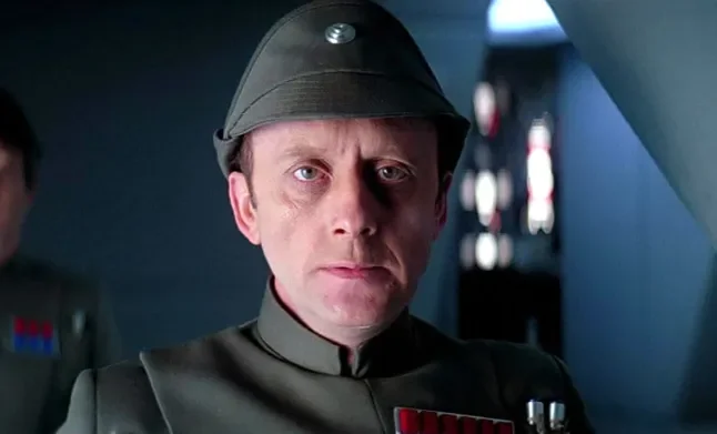 A man in uniform with a cap