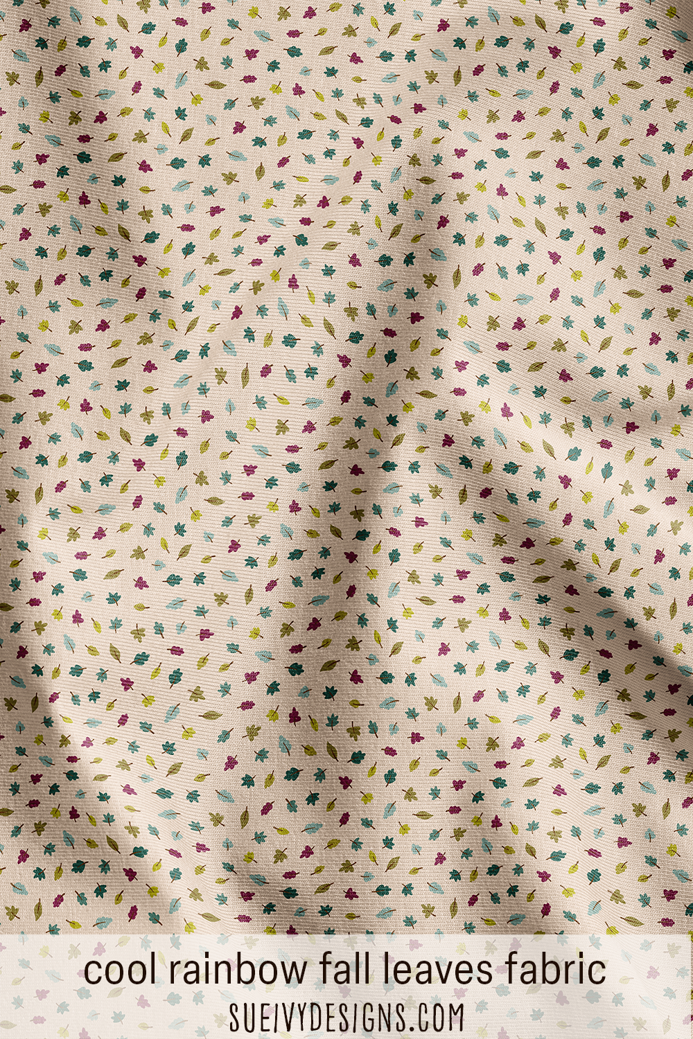 Scattered leaves fabric from the Autumn Rainbows collection by Sue Ivy Designs in a cool rainbow colorway of teal, light teal, and olive green.