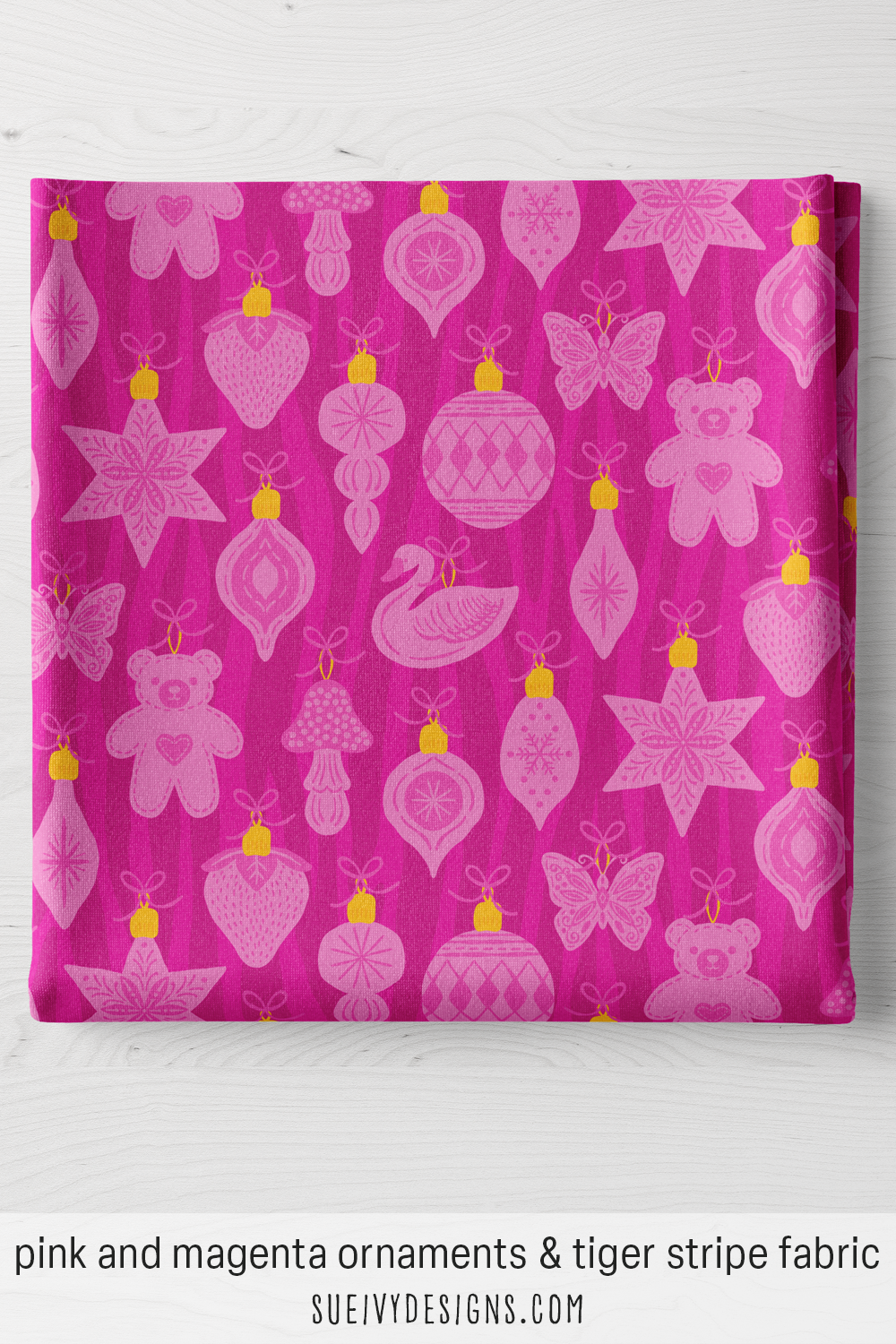 Pink and magenta ornaments — swans, teddy bears, strawberries, and mushrooms — on a dark tiger-striped ground, quilting fabric.