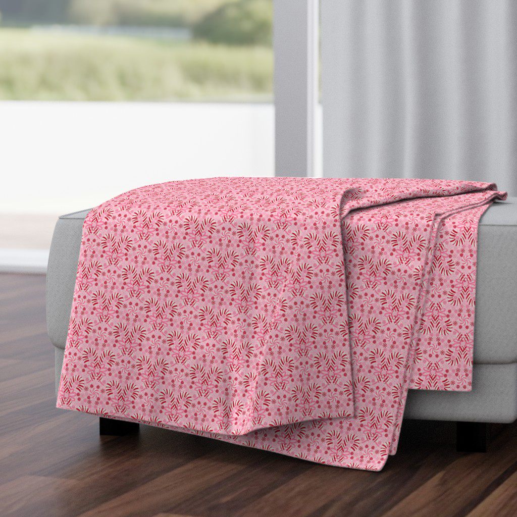 Throw blanket in the red and pinks candy cane and candies damask on light pink.