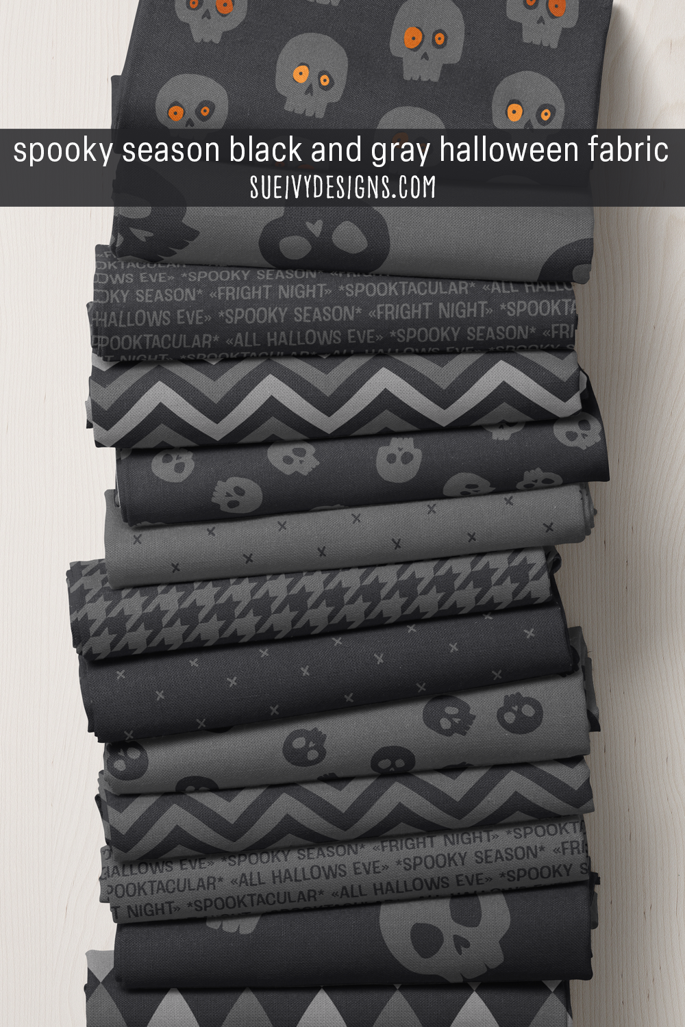 Tonal skulls, houndstooth, chevron, and 'all hallows eve' text in Spooktacular's black and gray colorway — the moodiest, most spooky-season register of the Halloween collection.