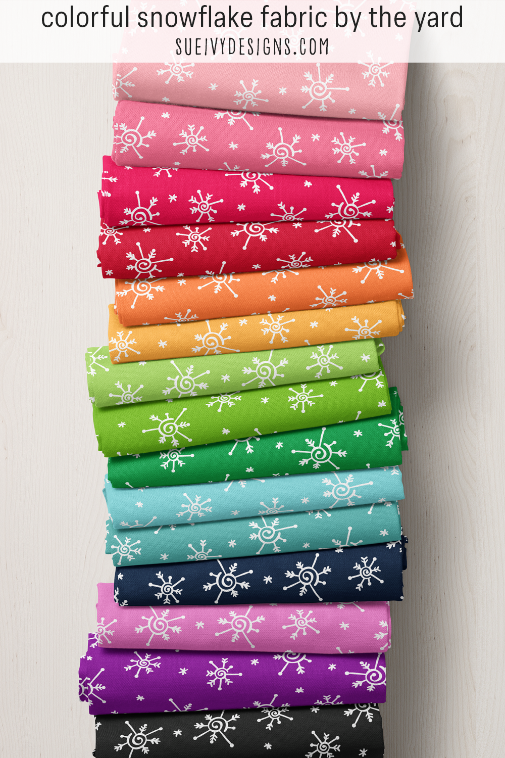 Snowflake fabric in fifteen colorways — whimsical white doodled snowflakes on ground colors that span the full rainbow.