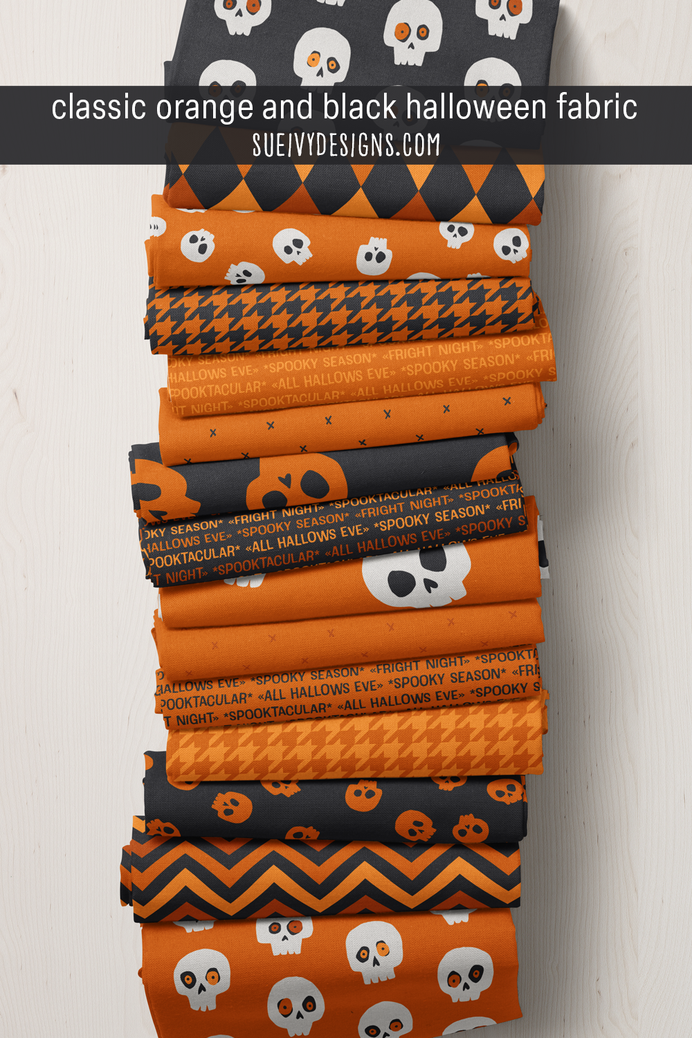 Spooktacular Halloween fabric in classic orange and black — quirky skulls, chevron, harlequin, houndstooth, and 'spooktacular' text print in the classic black-and-orange Halloween palette.