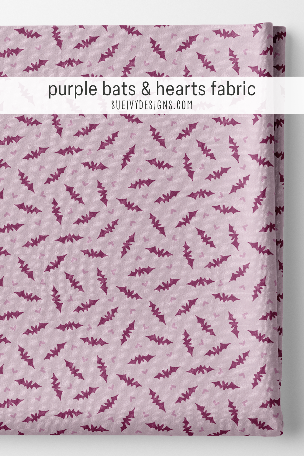 Dark purple bats with heart-shaped bodies and tiny mauve purple hearts on light purple, folded as a Halloween fat quarter