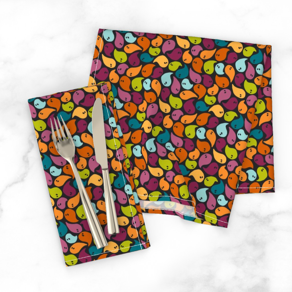 Cloth Halloween napkins in tossed rainbow ghosts on a dark ground from the Happy Haunting collection, bright for a festive table.
