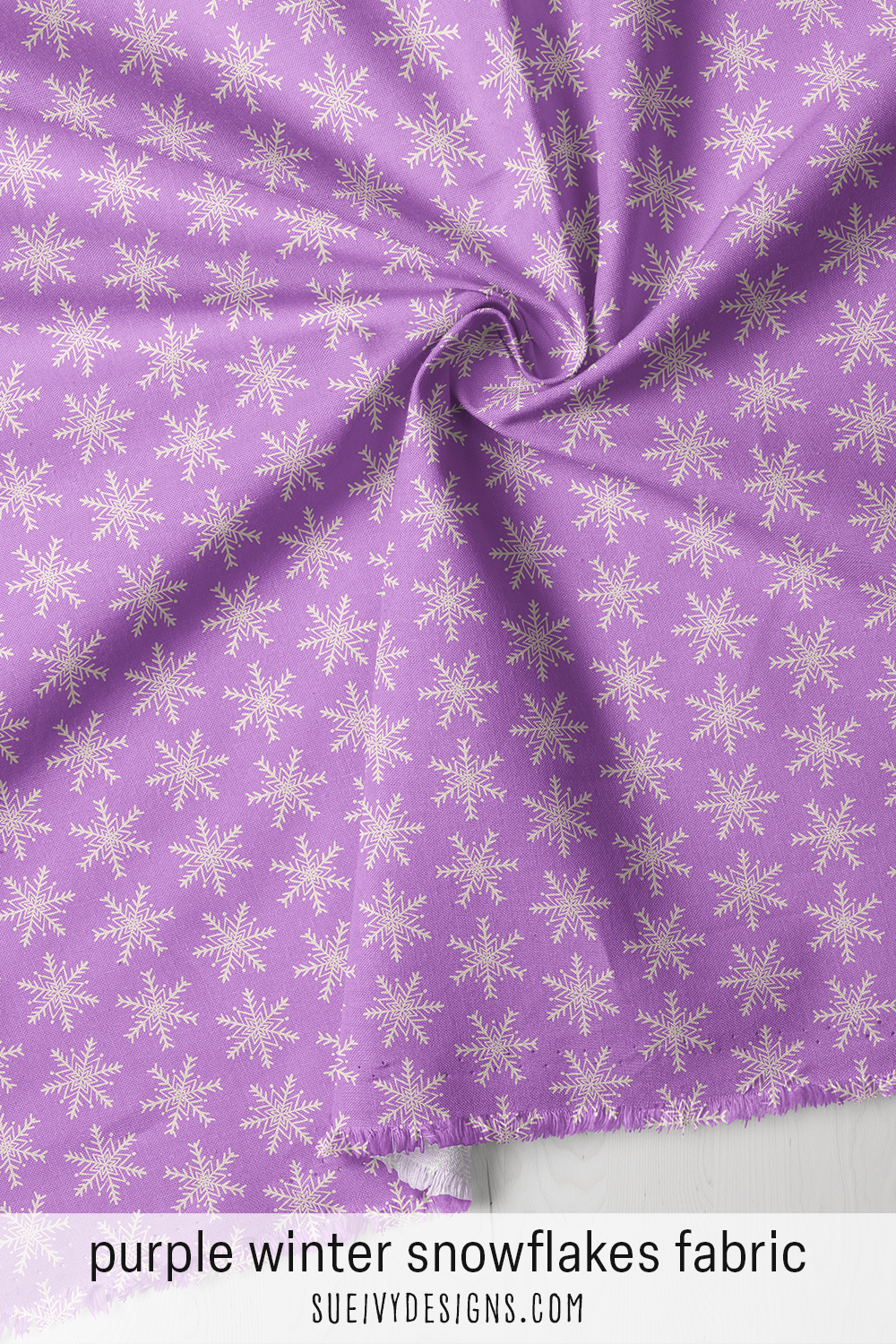 Candy purple winter fabric under big, close airy cream snowflakes — for curling up under a cozy quilt.