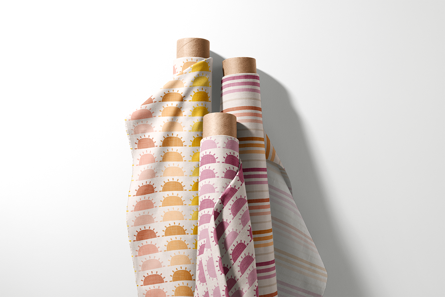 Three rolls of boho sun print and stripe fabric from the Boho Sunrise Sunset collection by Sue Ivy Designs