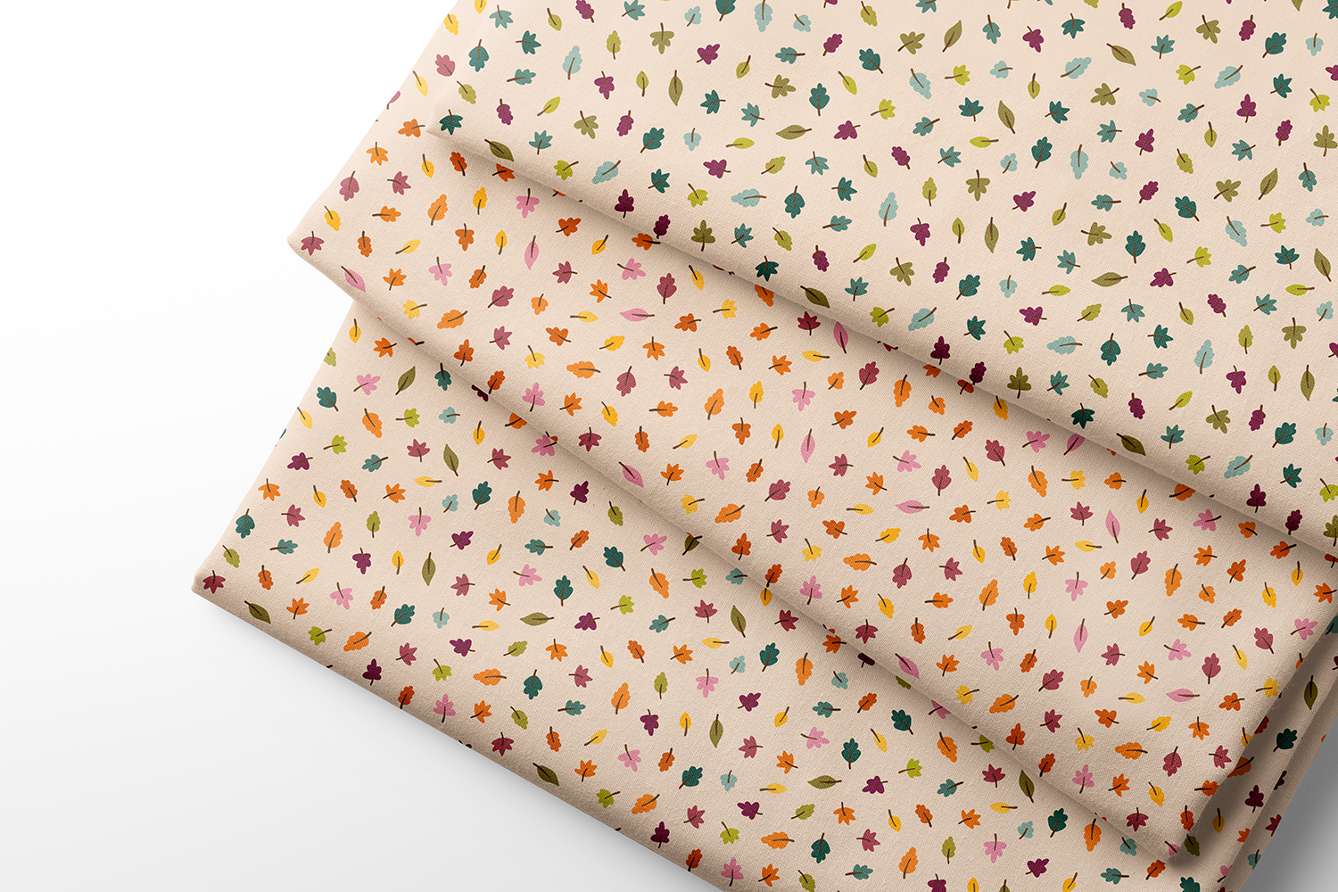 Scattered leaves fabric from the Autumn Rainbows fall collection by Sue Ivy Designs, shown in three multicolor rainbow colorways on warm cream.