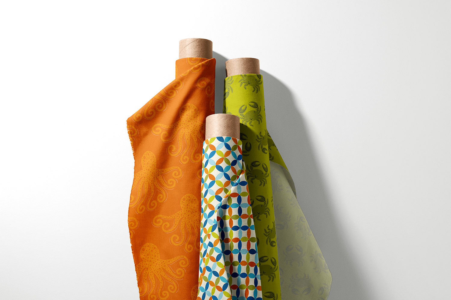 Three rolls of octopus, geometric tile, and crab fabric from the Mediterranean Sea collection by Sue Ivy Designs