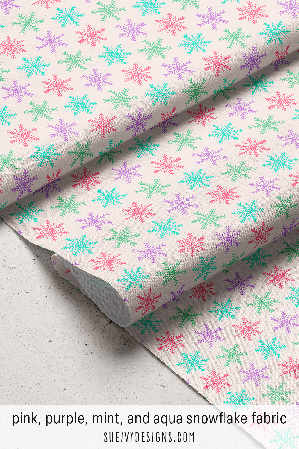 Airy hand-drawn snowflakes tossed in candy pink, aqua, mint, & purple on cream — for a bright multicolor winter quilt.