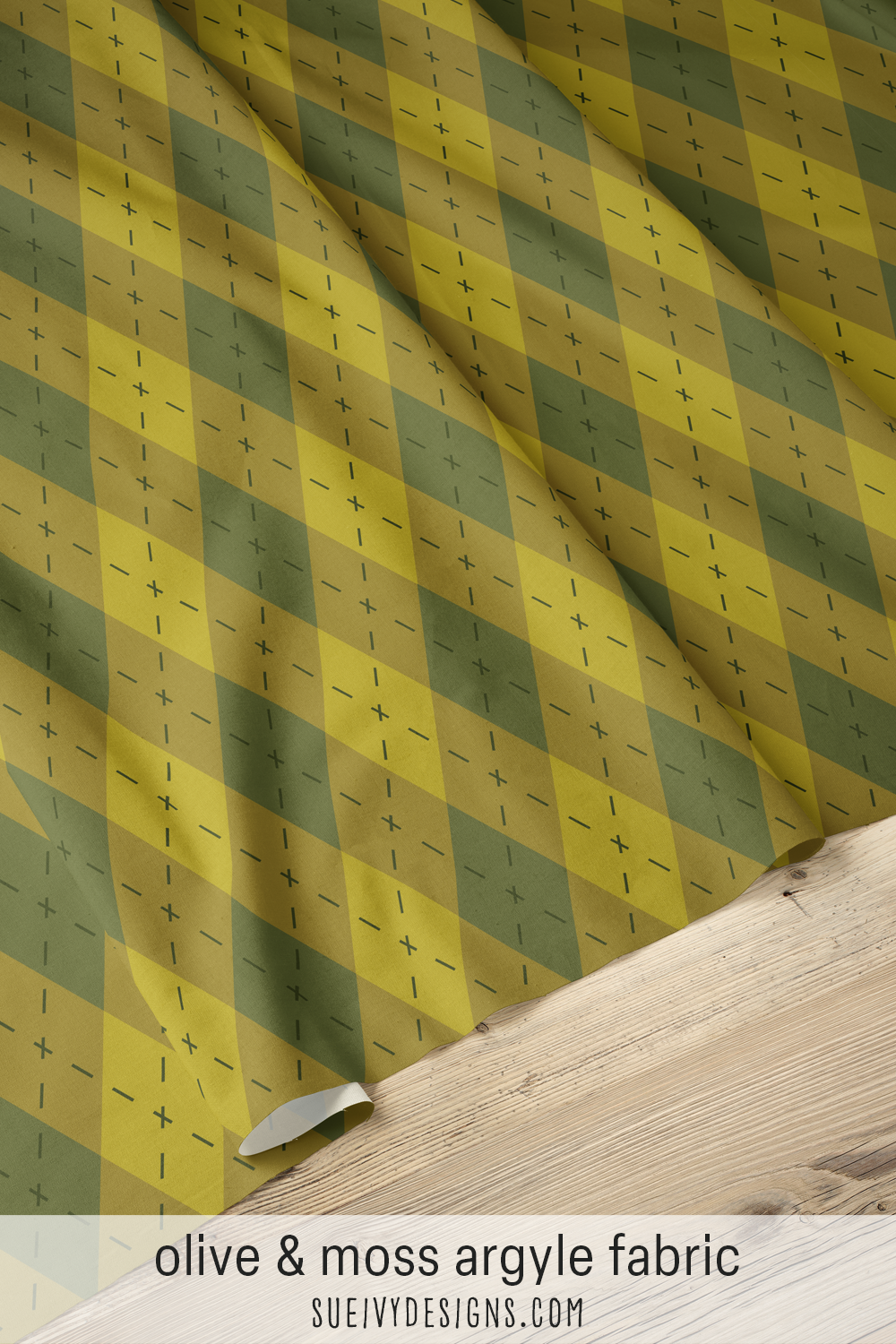 Olive and moss argyle fabric spread out to show the full repeat — big diamonds and dashes for apparel sewing.