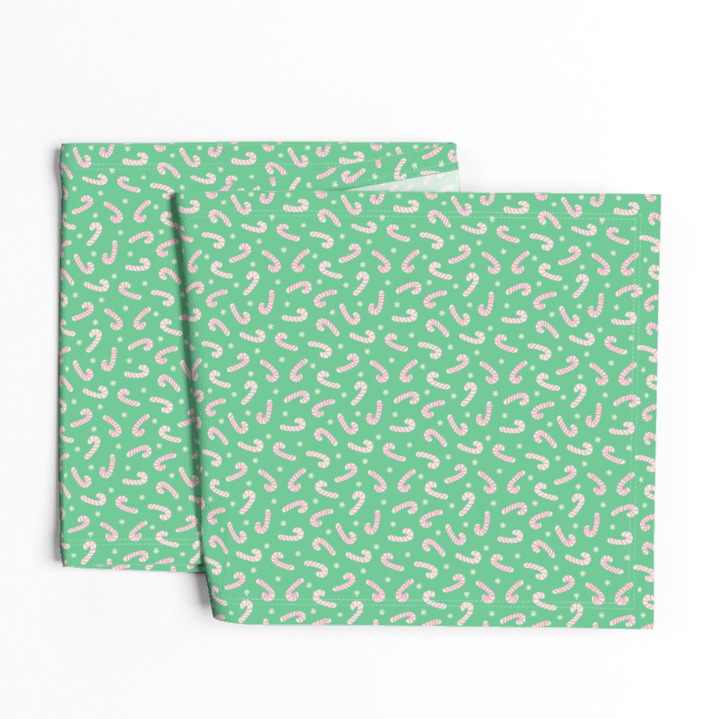 Table runner in candy pink and cream candy canes and snowflakes on mint green.
