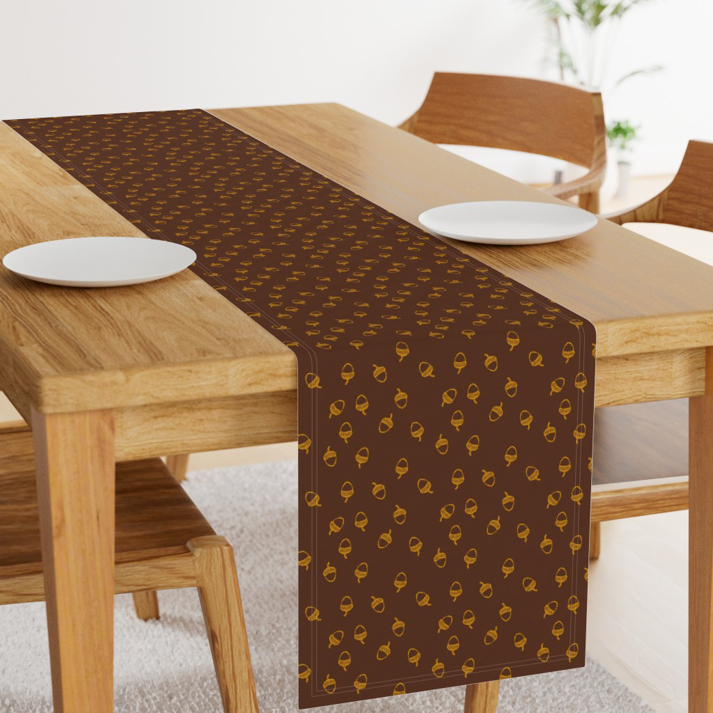 Gold tossed acorns on dark chocolate brown table runner, for a fall tablescape.