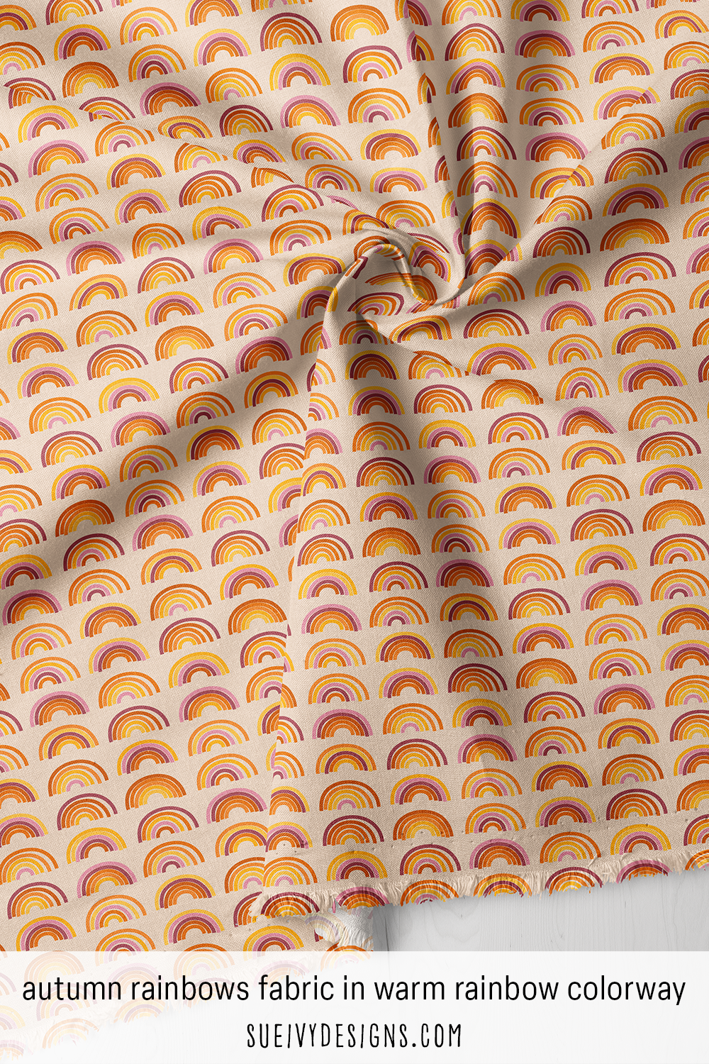 Fabric with rainbow arcs in pink, red, orange and yellow on warm cream — the warm rainbow colorway from Autumn Rainbows.