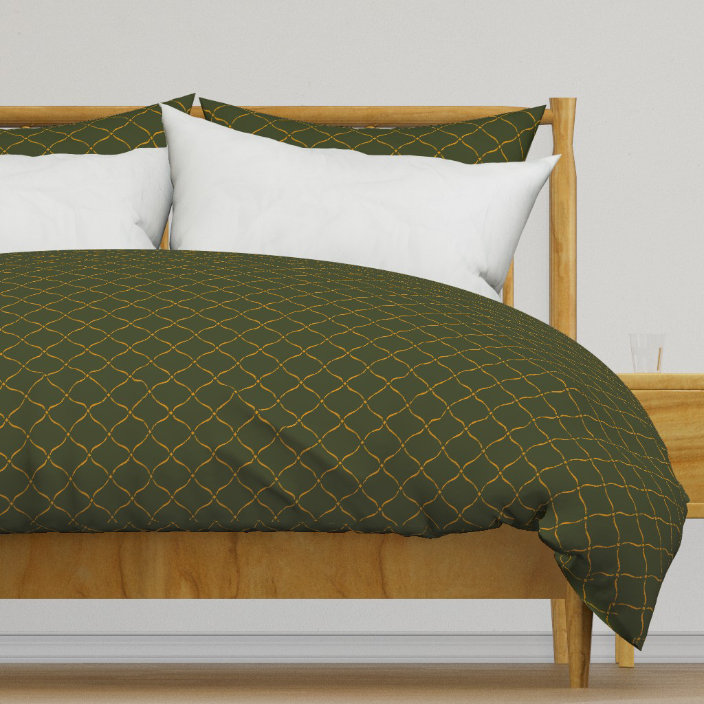 Gold and dark forest green ogee with stars duvet cover, a moody Halloween bedroom idea that carries past October.