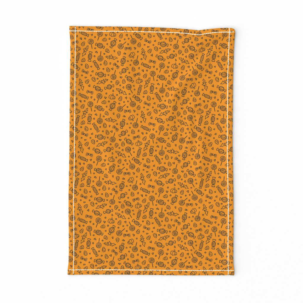 Doodled Halloween candy tea towel in black and orange, available ready-made on Spoonflower in the Spookilicious collection.
