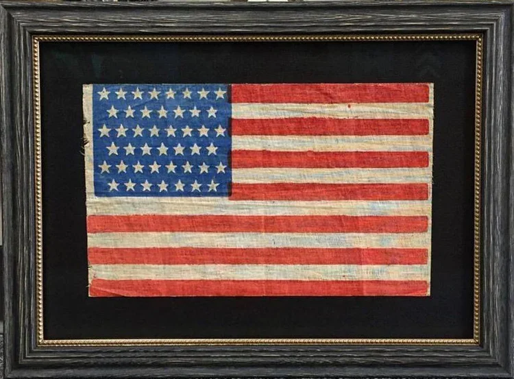 A framed American flag with a black background.  custom framing brookline pictureplacebrookline.com