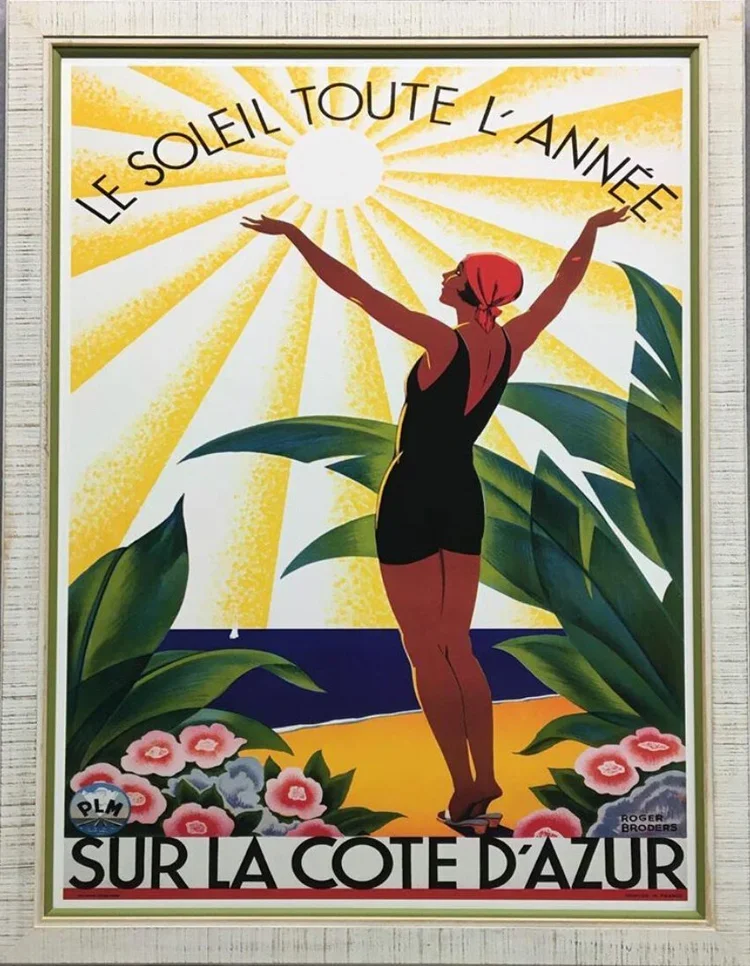 Vintage poster featuring a woman in a black swimsuit with red headscarf standing on a beach with large green leaves and pink flowers.  custom framing brookline pictureplacebrookline.com