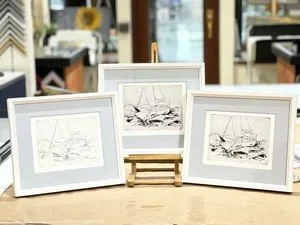 Three framed black and white sketches of fish displayed at custom framing brookline pictureplacebrookline.com